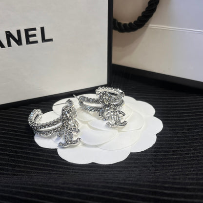C.C brand silver diamond-encrusted bow earrings