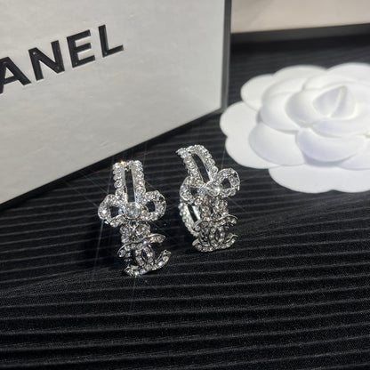 C.C brand silver diamond-encrusted bow earrings