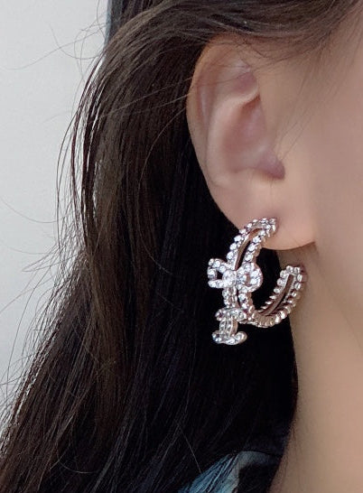 C.C brand silver diamond-encrusted bow earrings