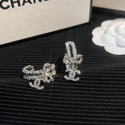 C.C brand silver diamond-encrusted bow earrings