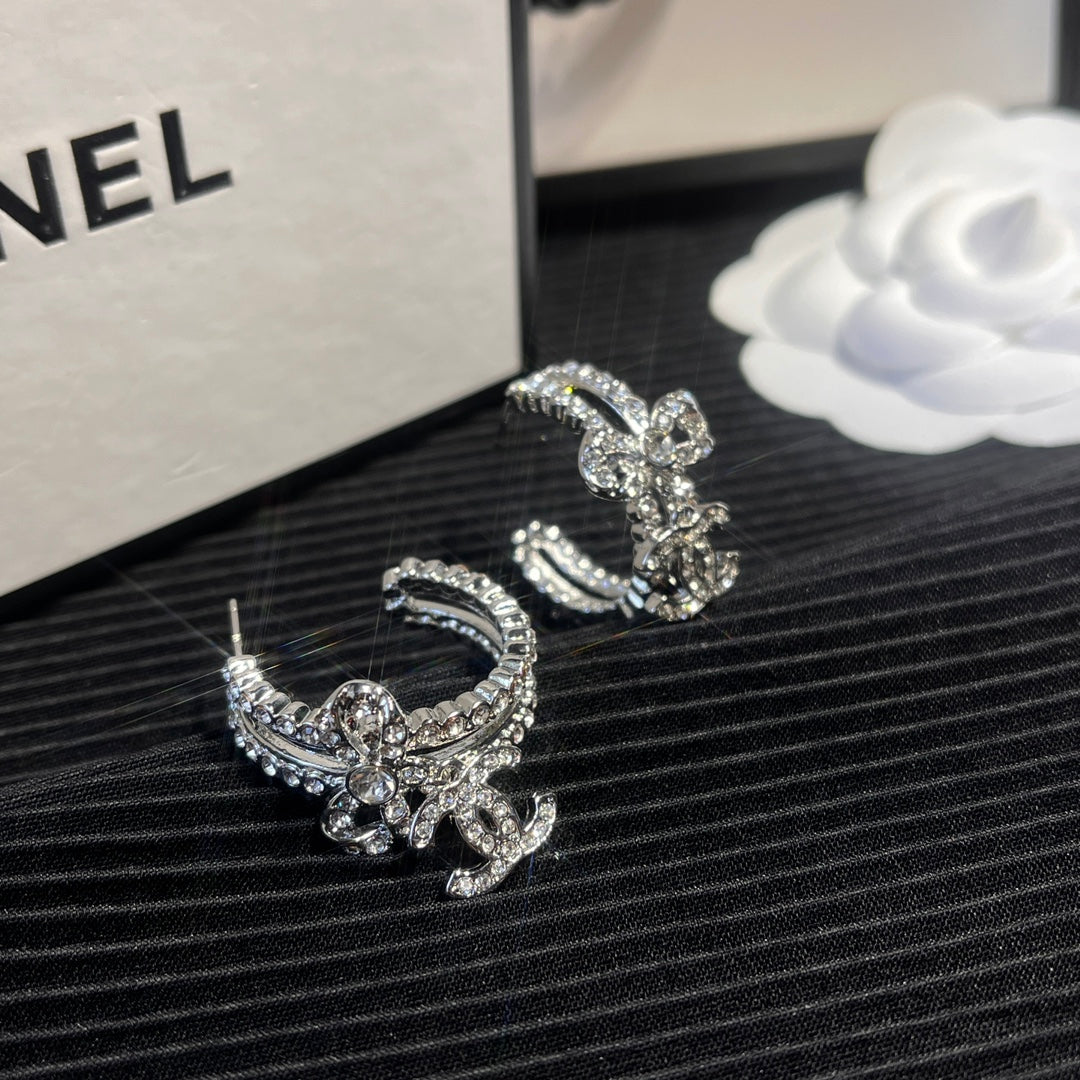 C.C brand silver diamond-encrusted bow earrings